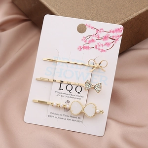 Dreiteiliges goldenes Haarklammer-Set mit Strass, Perlen und Schleifen-Details
