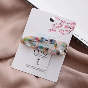 Colorful marble effect acrylic hair clip with duckbill clip on elegant satin background
