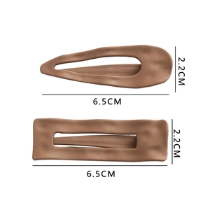 Detail view of brown matte hair clips in teardrop and rectangle shapes measuring 6.5cm