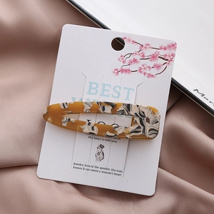 Water drop shaped amber marble acrylic hair clip on cherry blossom display card