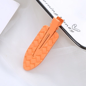 Leuchtend orangefarbene Haarspange mit Webstruktur und Metallclip für kreative Frisuren