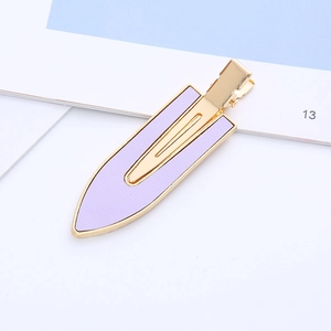 Detailed view of lavender purple leather hair clip with elegant gold metal edges and grip