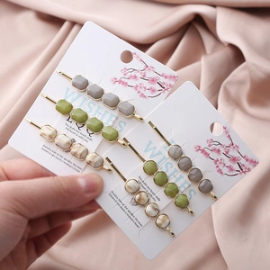 Detail of 6-piece hair clip set with marble stone texture and gold metal base