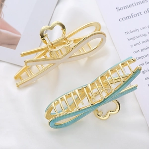 Elegant gold-plated metal hair claw clips with heart-shaped grip in cream and light blue