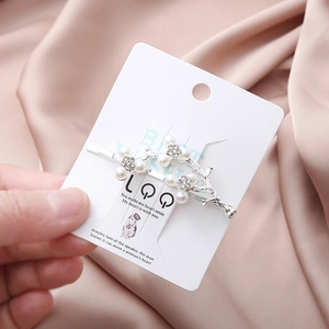 Elegant branch-shaped hair clip with pearls and rhinestones on a silk background