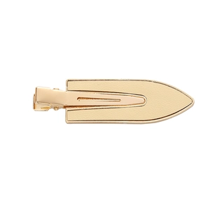 Minimalist beige leather and gold metal hair clip for women with leaf shaped design