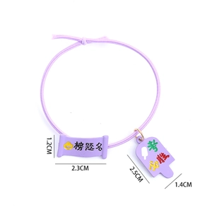 Purple elastic hair tie with academic success charms and lucky charms for students