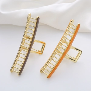 Large acetate shark hair clip for women with amber texture and elegant gold metal frame