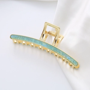 Minimalist long hair claw clip with gold metal and blue marble texture inlay