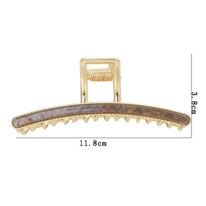 Golden metal hair claw clip with tortoise shell texture, dimensions 11.8cm by 3.8cm