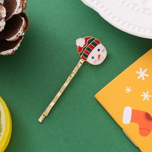 Pince à cheveux bonhomme de neige avec clochettes festives sur fond vert de noël