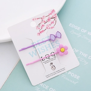 Lot de barrettes à fleurs et nœud violet sur carte décorative cerisier