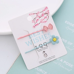 Lot de barrettes à fleurs douces avec nœud rose et marguerite bleue sur carte