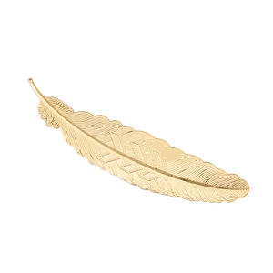Elegant gold metal feather hair clip with detailed texture on white background