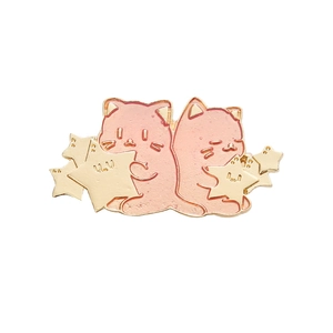 Kawaii enamel pin featuring two pink hugging cats and golden stars on white background