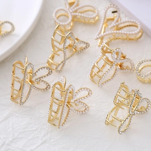 Elegant gold metal hair claw clips with heart and butterfly shapes and pearl rhinestones
