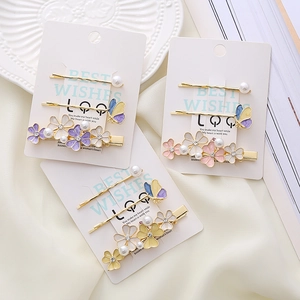 Set of 3 floral hair clips featuring enamel flowers, pearls, and butterflies in pastel tones