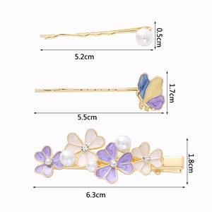 Three-piece hair clip set including floral, butterfly, and pearl designs with dimensions