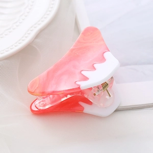 Macro view of pink and white gradient acetate hair claw with high-quality metal spring
