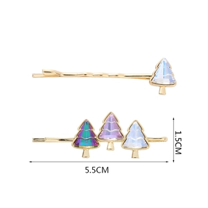 Detailed view of Christmas tree hair pins with gold plating and colorful crystals