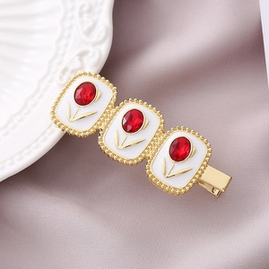 Elegant gold tulip crystal duckbill hair clip with red gemstone and white enamel finish
