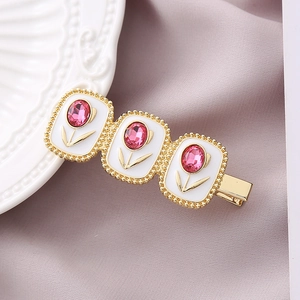 Elegant gold tulip crystal hair clip with pink rhinestones and white enamel finish