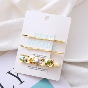 Golden geometric hair clip set with colorful crystal rhinestones on white display card