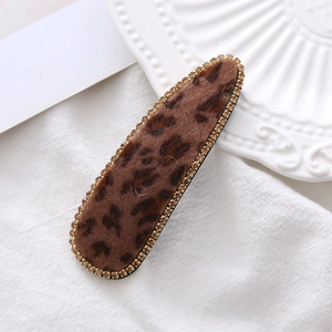 Leopard print velvet hair clip with sparkling rhinestones in a teardrop shape style