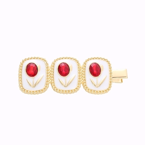 Elegant gold-tone tulip duckbill hair clip with red crystals and white enamel petals