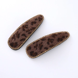 Plush leopard print hair clips with sparkling rhinestone trim on white background