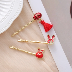 Detail of red festive hair clips featuring lanterns, lucky rabbits, and tassels for Chinese New Year