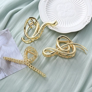 Three-piece gold metal hair claw clips set with chain and wavy geometric designs