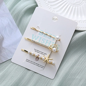 Lot de trois barrettes marines avec métal doré, perles et strass brillants