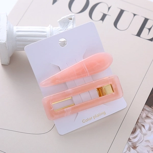 Pink marble texture acetate hair clip set with gold metal backing on white card