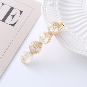 Elegant gold hair clip with shimmering gold foil resin beads for women's hairstyle