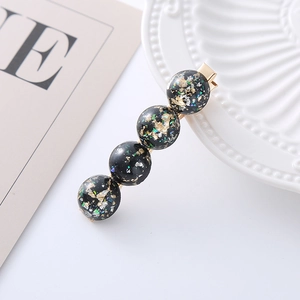 Sparkly black resin hair clip with gold foil flakes and golden metal duckbill base