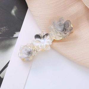 Elegant floral duckbill hair clip with marble textured resin flowers on a gold base