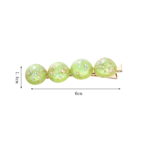 Detail view of 6cm grass green hair clip with resin gold foil and silver flakes
