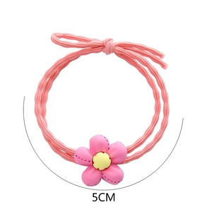 Détail de l'élastique à cheveux fleur rose avec nœud et diamètre de 5 cm affiché