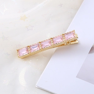Barrette à cheveux élégante en cristal rose avec cinq pierres sur base dorée brillante