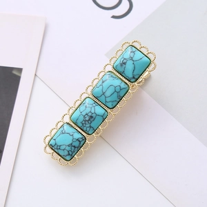 Golden lace hair clip with four square turquoise stones featuring vintage floral edges