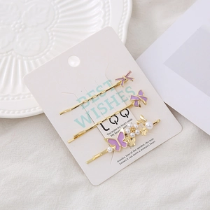 Lot de trois barrettes dorées avec nœuds papillon violets et perles blanches élégantes