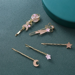 Set di 5 fermagli per capelli dorati con luna rosa e stelle su sfondo blu scuro intenso