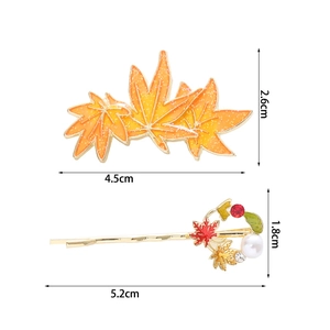 Detail view showing autumn maple leaf hair clips with glitter finish and size dimensions