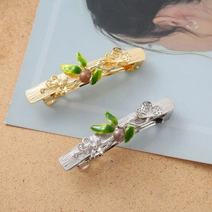 Set of gold and silver butterfly leaf hair clips with green enamel and pearls