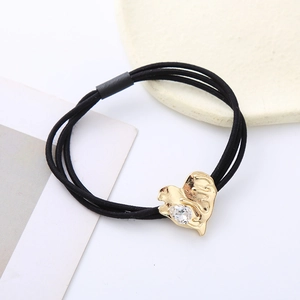 Three-strand elastic hair tie with a gold molten heart pendant and pear-shaped crystal