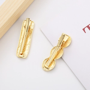 Set of two vintage gold duckbill hair clips with elegant brushed metal texture finish