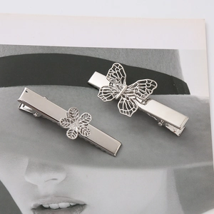 Elegant silver butterfly and flower metal hair clips set on stylish magazine background