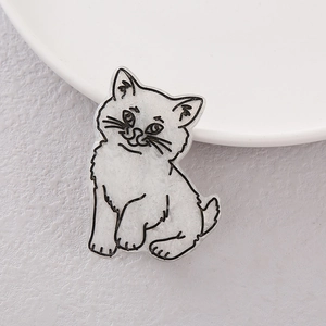 Cute white cat hair clip with glitter finish shown on a white ceramic plate