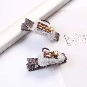 Pair of brown striped plush hair clips with rhinestone detail and handmade ribbon